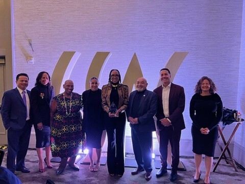 Group of people receiving an award at a formal event